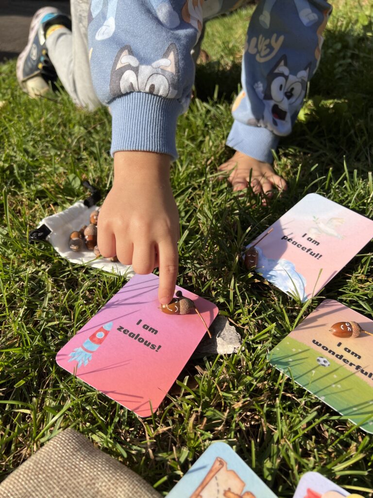 Child playing with positive affirmation cards and emotion toys.
